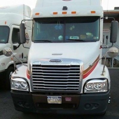 2005 white freightliner tractor with gold and red stripes