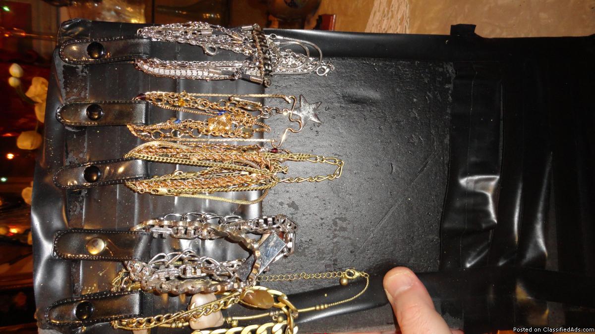 Suit case full of various jewelry items for sale.