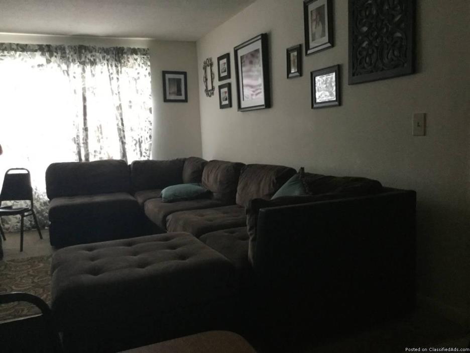 Brown sectional and ottoman, 0