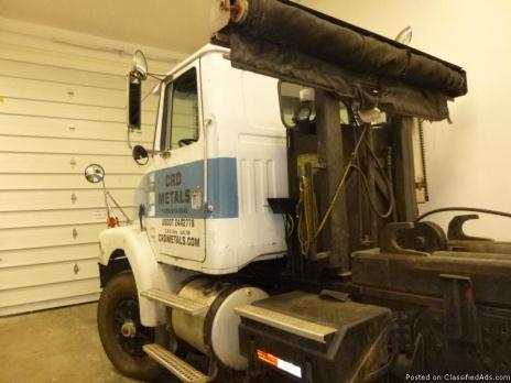 For Sale -  White/GMC Volvo Roll-Off Truck