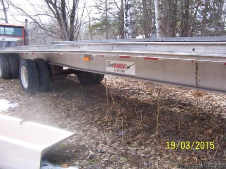 1999 raven flat bed trailer with conasota roll top.
