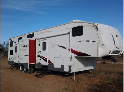 Well maintained and sought after model of toy hauler with 4 queen beds!